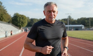 Man running on a track, representing cardio and anaerobic workouts